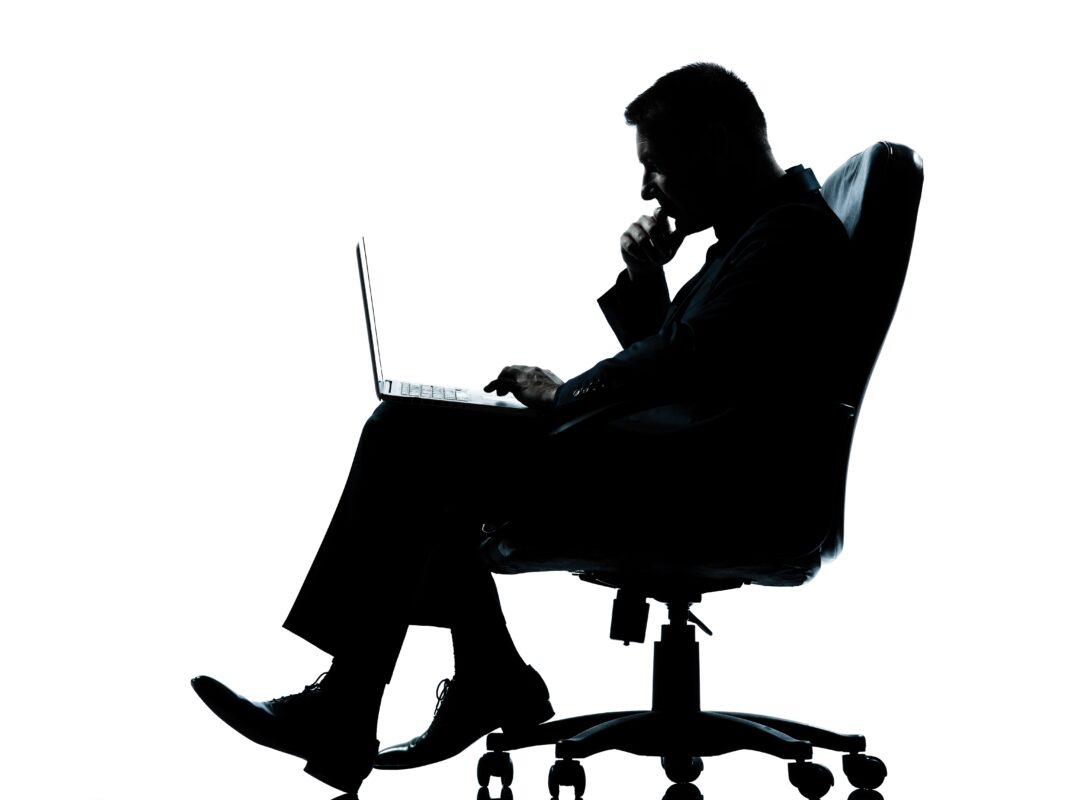 one business man computer computing sitting in armchair silhouet